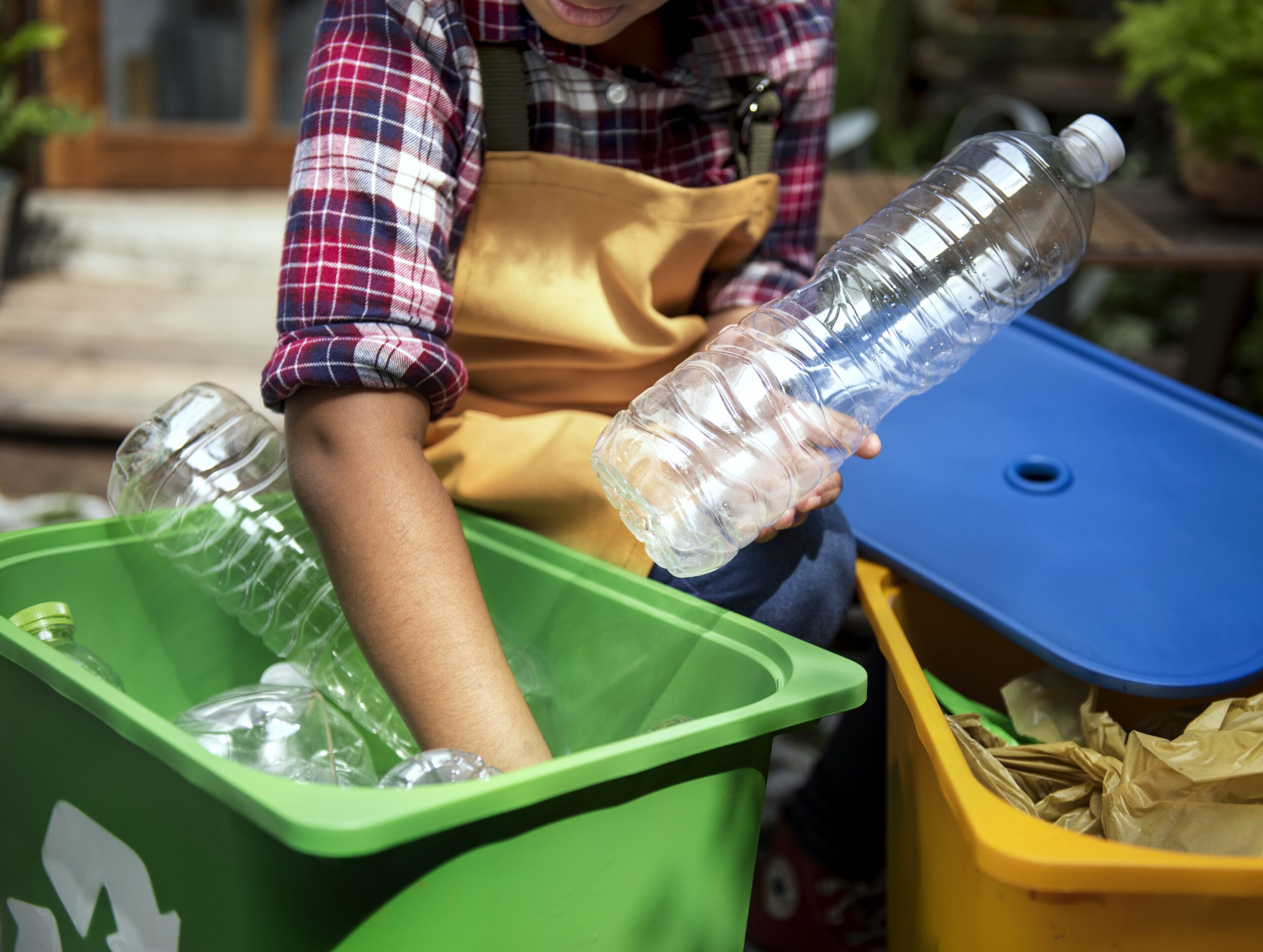 Closeup of hand holding clear plastic bottles