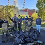 Group posing with trash and tire